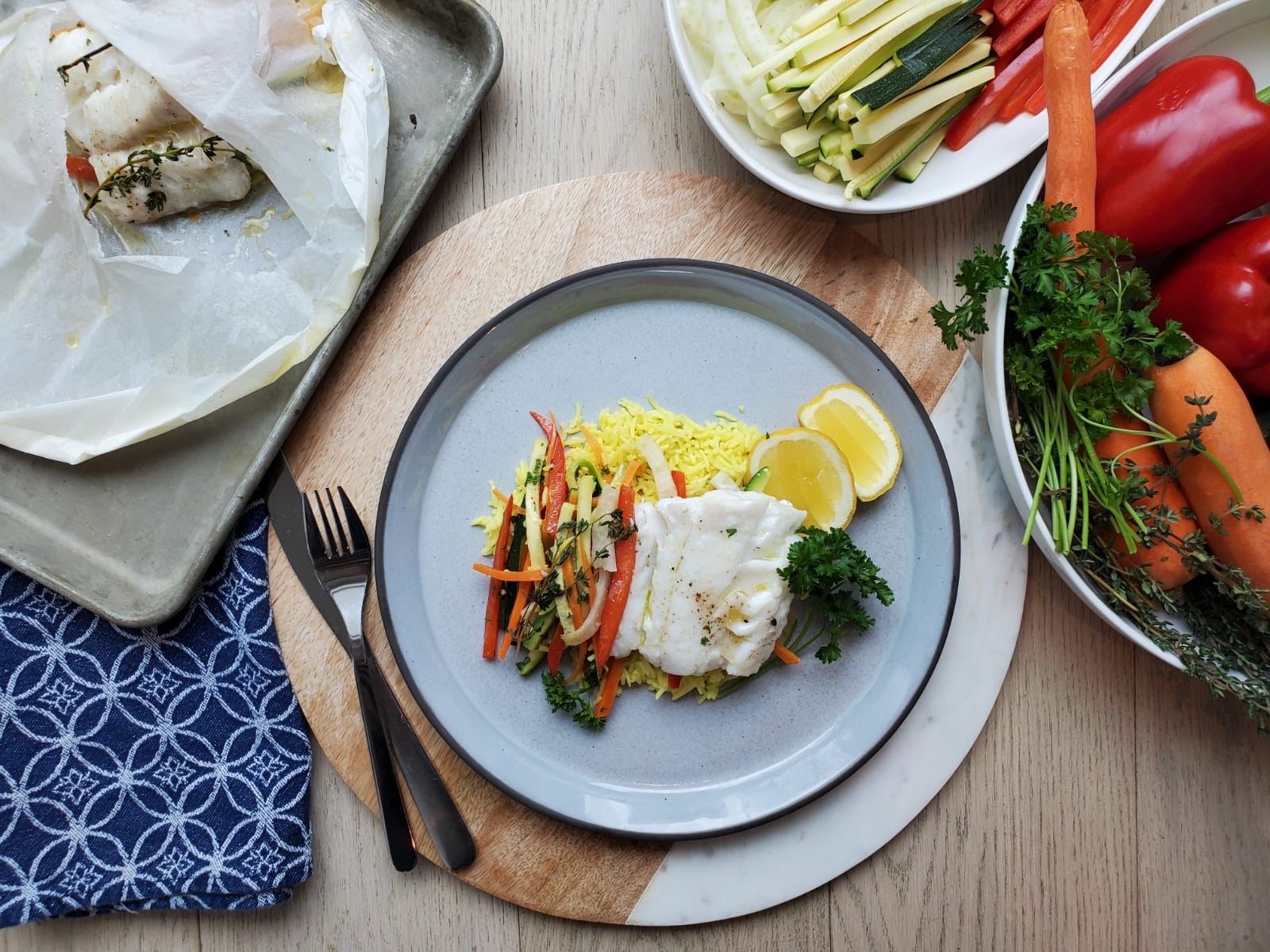 Baked cod en papillote with mixed vegetables