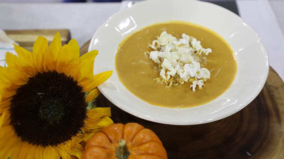 Pumpkin soup topped with cheesy popcorn
